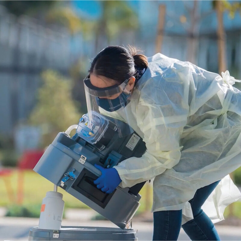 picture of scientist collecting a wastewater sample